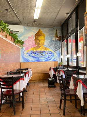 A golden Buddha blessing diners as they enjoy their Nepali meal.
