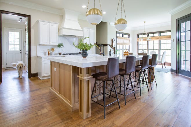 This massive kitchen island is a great example of how builders are either designing or reimagining the popular common kitchen area like this one by Bella Tucker. Now, kitchen islands need to function as secondary home offices and spaces for schoolwork, so they need to have ample counter space, plenty of seating and even additional legroom.