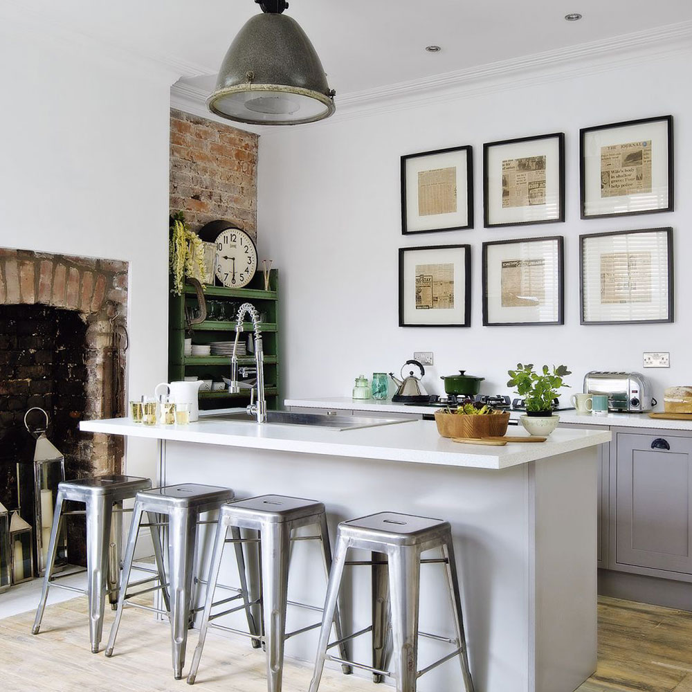 Rustic grey kitchen with exposed brickwork and gallery wall