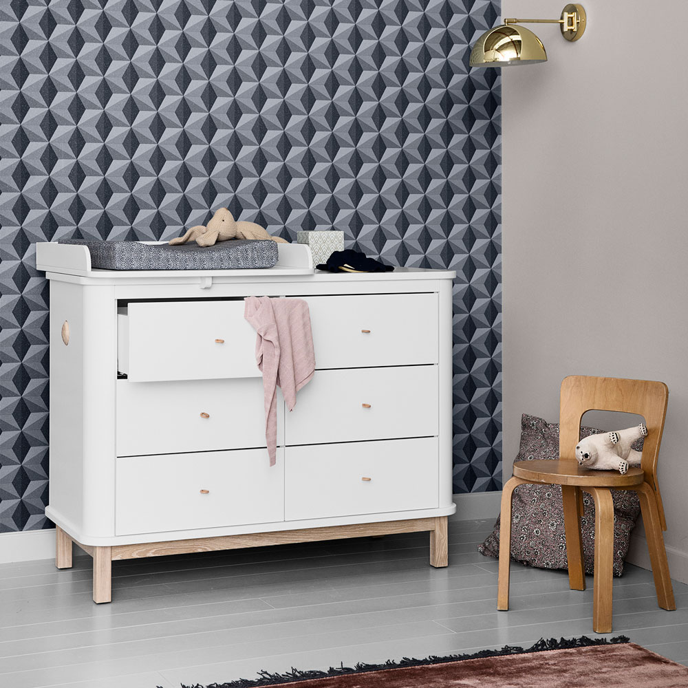 grey child's room with navy geometric wallpaper and white dresser